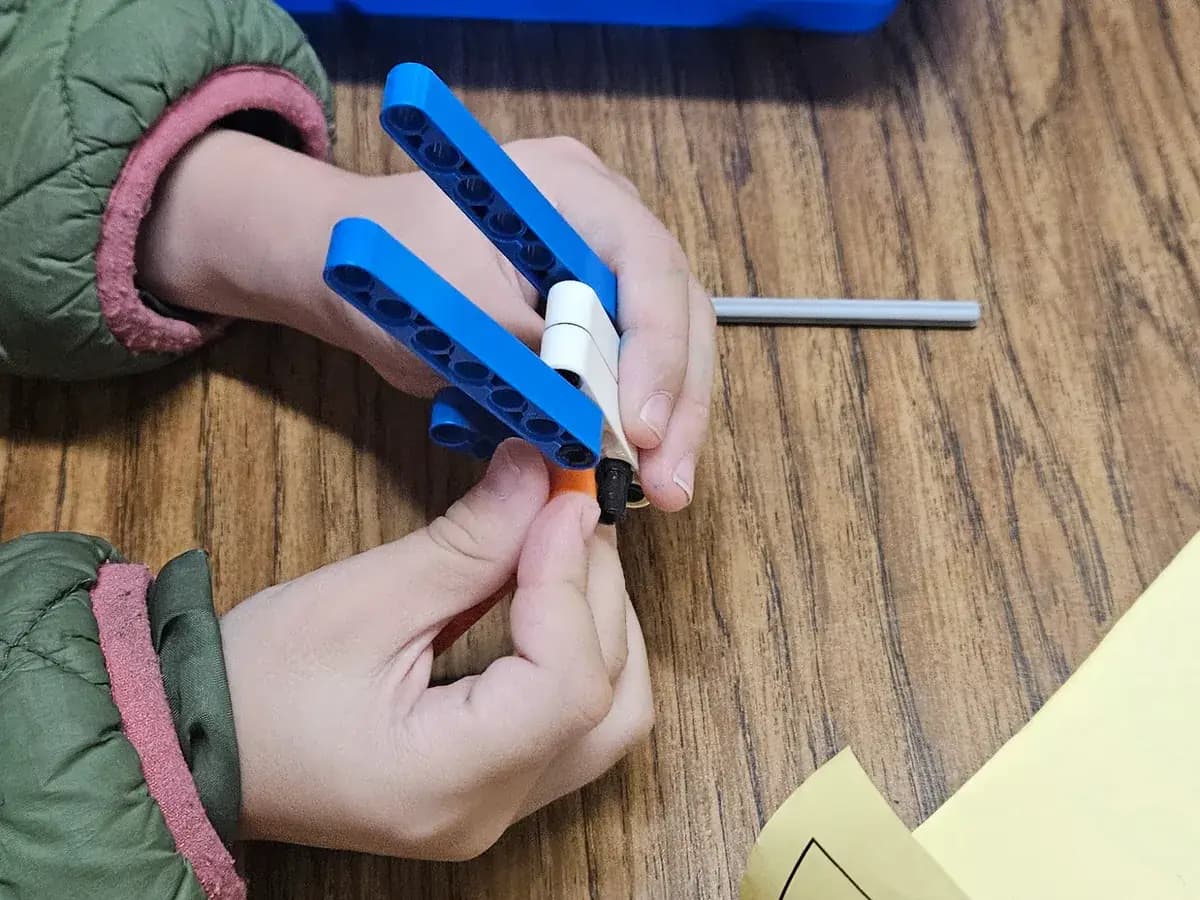 Small hands assembling a robot