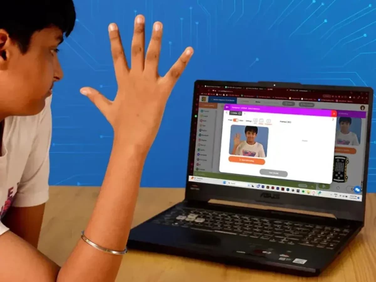 A student controlling an on-screen game with a hand gesture