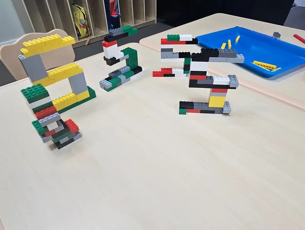 LEGO letter sculptures built by the class, standing on the table